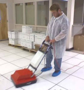 Cleaning and polishing raised flooring panels using specialized, high-suction equipment